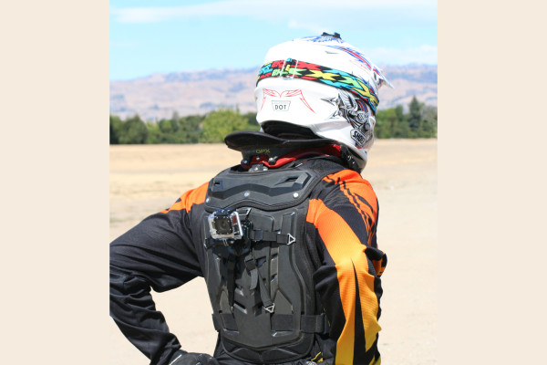 Image of rider wearing Fox ProFrame and Leatt neck brace; GoPro Hero 3 is rear-mounted using the Moto Flak Mount